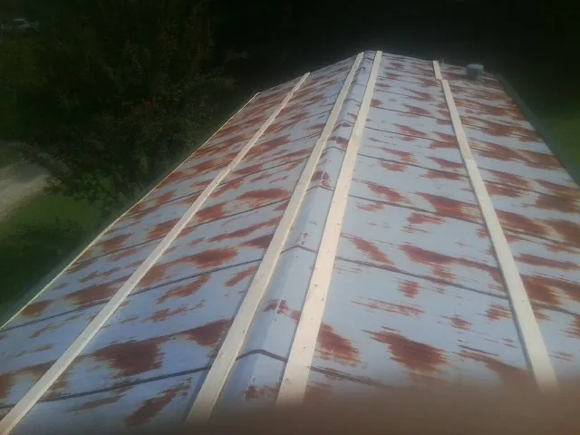 Rusted metal roof panels with new wood purlins before replacement — Storm Damage Roof Repair in Tall Timbers by Roofing Brothers